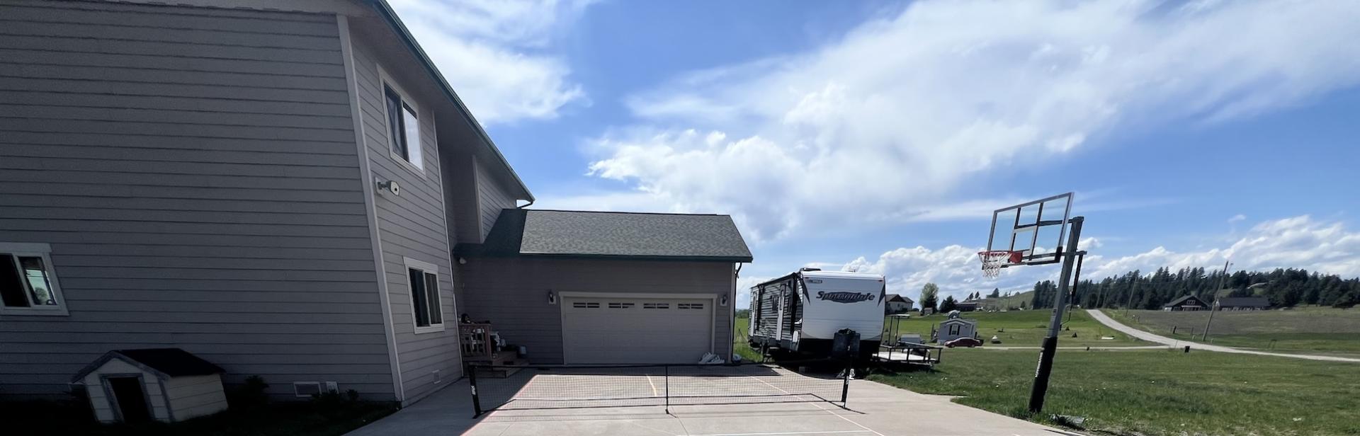 Jody's house, the day she and her family made a pickleball court in the driveway.