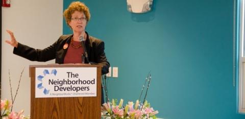 Ann Houston stands behind a podium