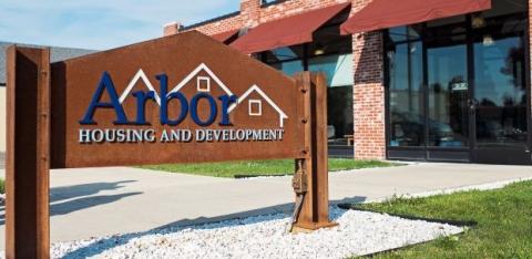 A sign in front of Arbor Housing Development.