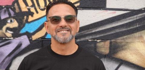 Michael Ulibarri against a colorful background