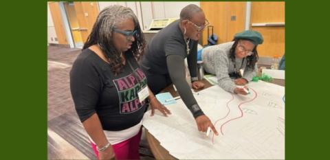 A team from NHS of LA County works on a plan for their project.